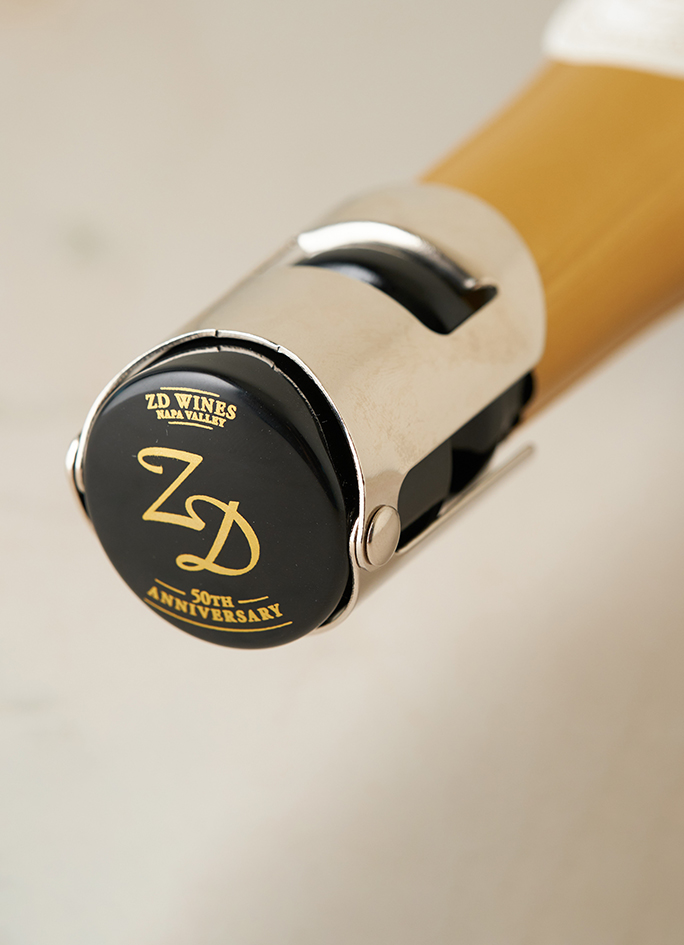 A 50th Anniversary ZD Wines champagne stopper on a bottle of sparkling wine