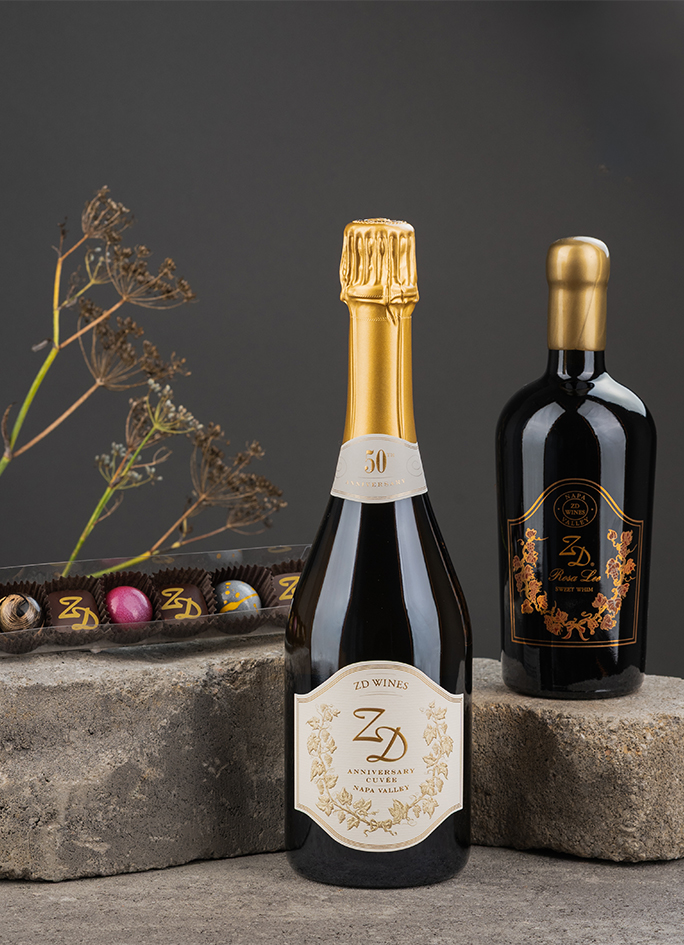 A luxurious photo of ZD's Sparkling Cuvée alongside a Rosa Lee Sweet Whim and 6 pieces of Kollar Chocolates
