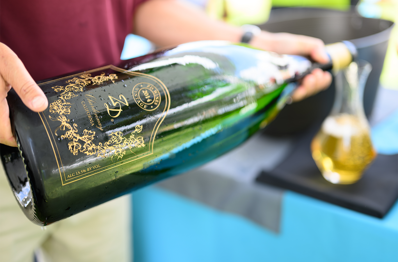 A large-format bottle of ZD Wines being oured into a decanter.