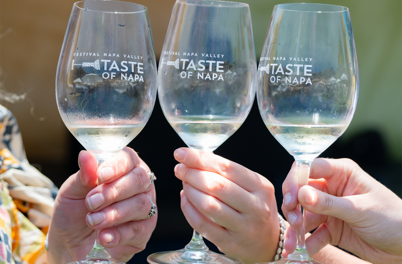 3 Taste of Napa wine glasses being cheered