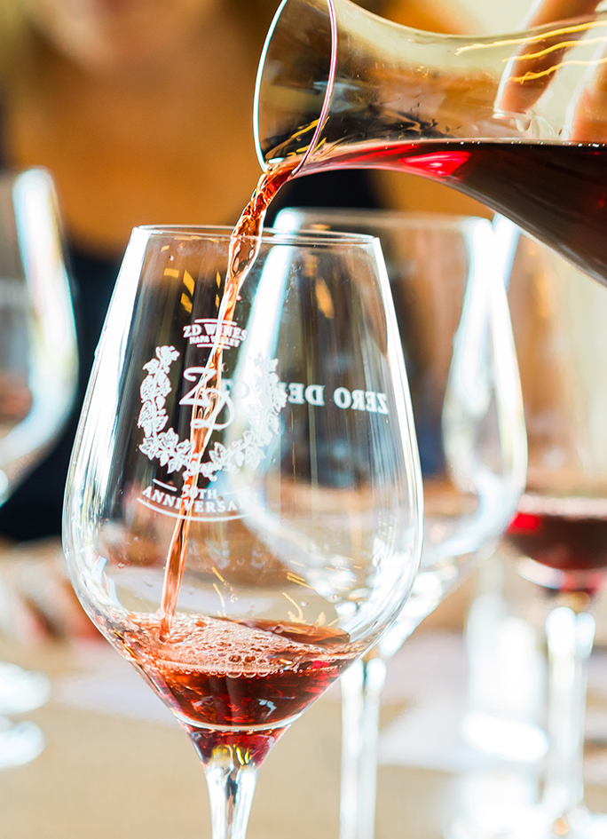 Red wine being poured into a ZD Wines glass.