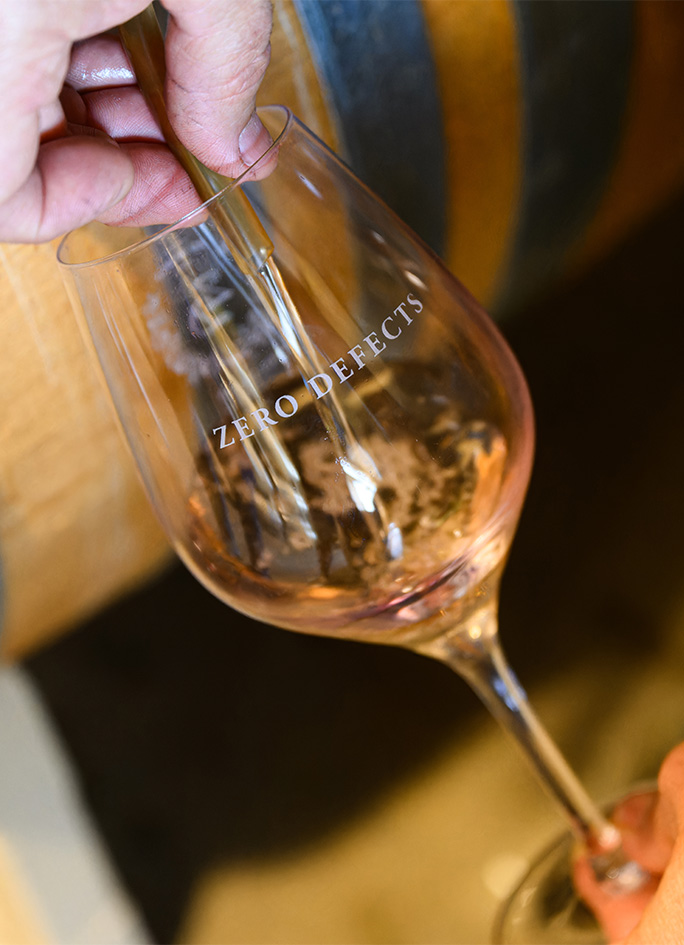 A barrel sample of wine being poured into a ZD Wines glass