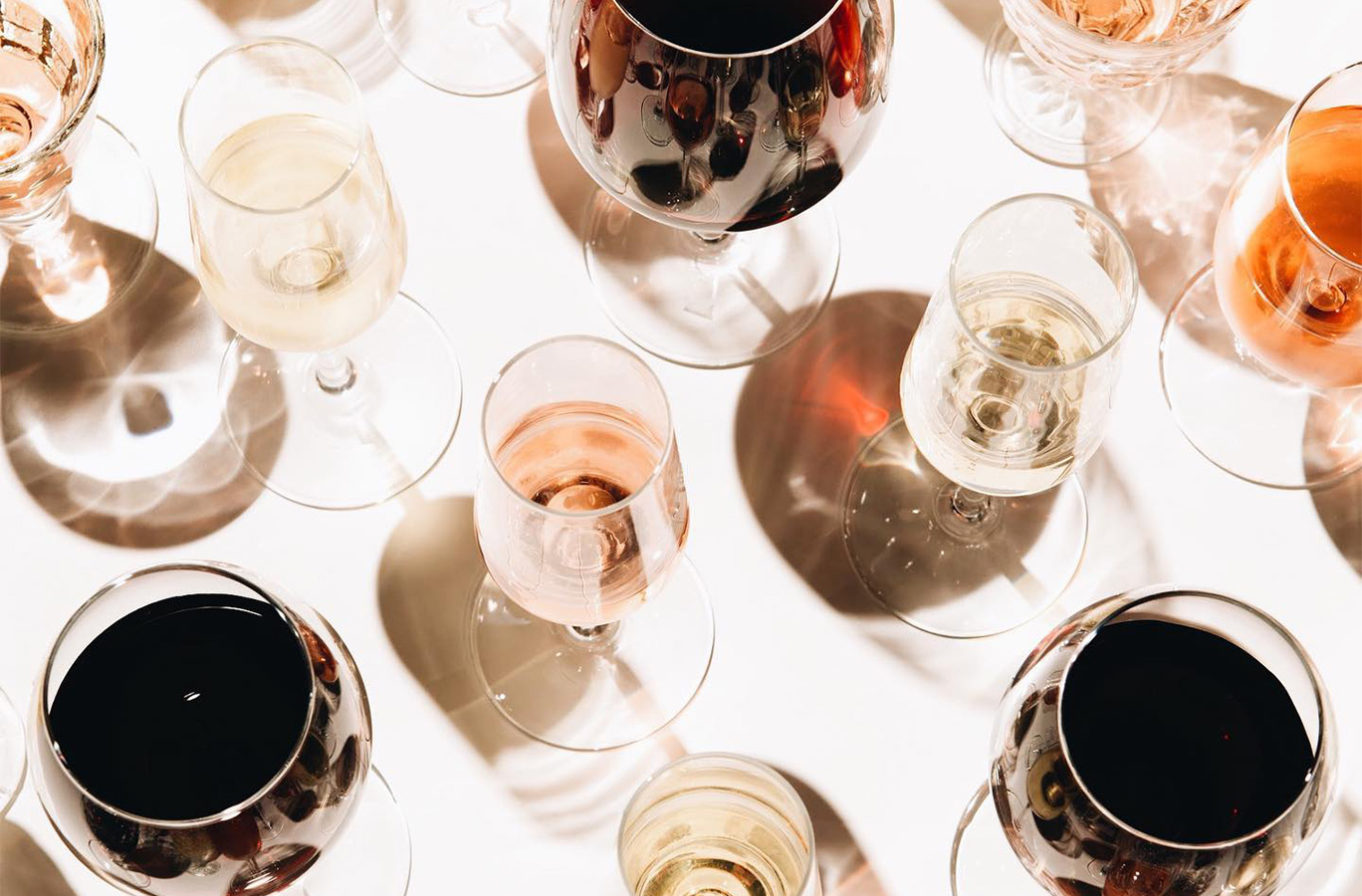 A view above several full glasses of wine on a table