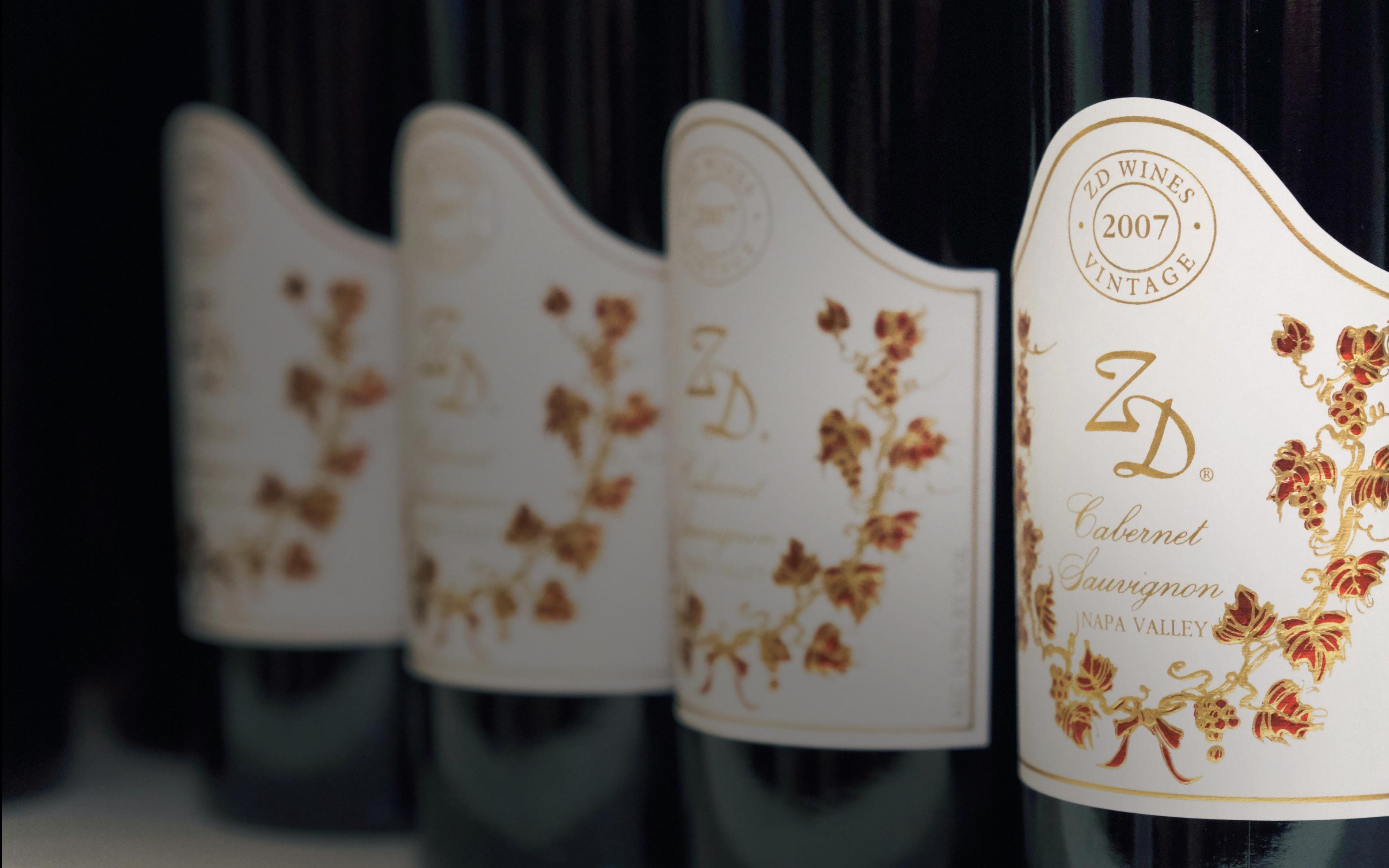 A closeup of 4 bottles of ZD Cabernet Sauvignon in a line.