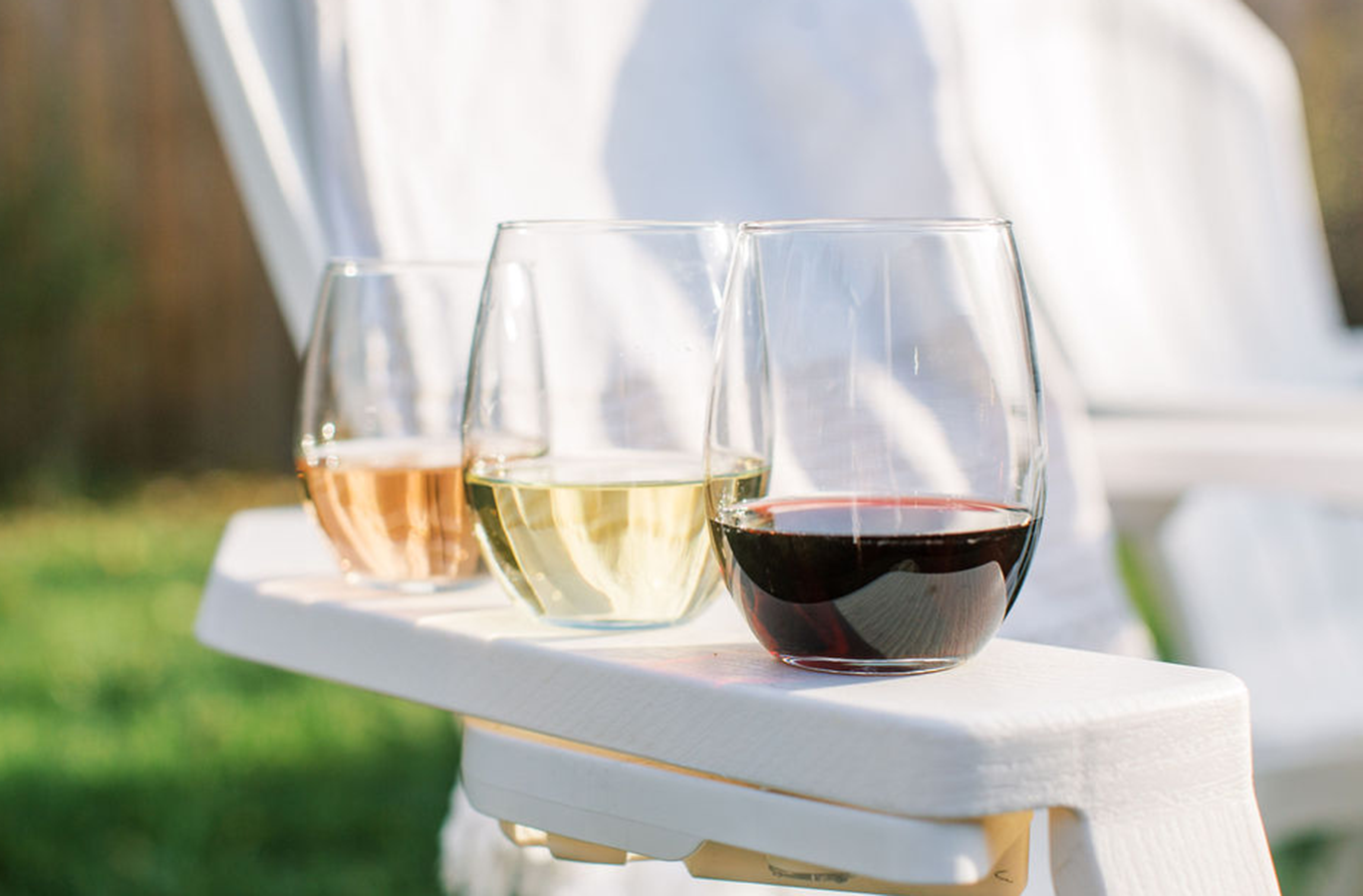 3 glasses of wine on a chair's arm