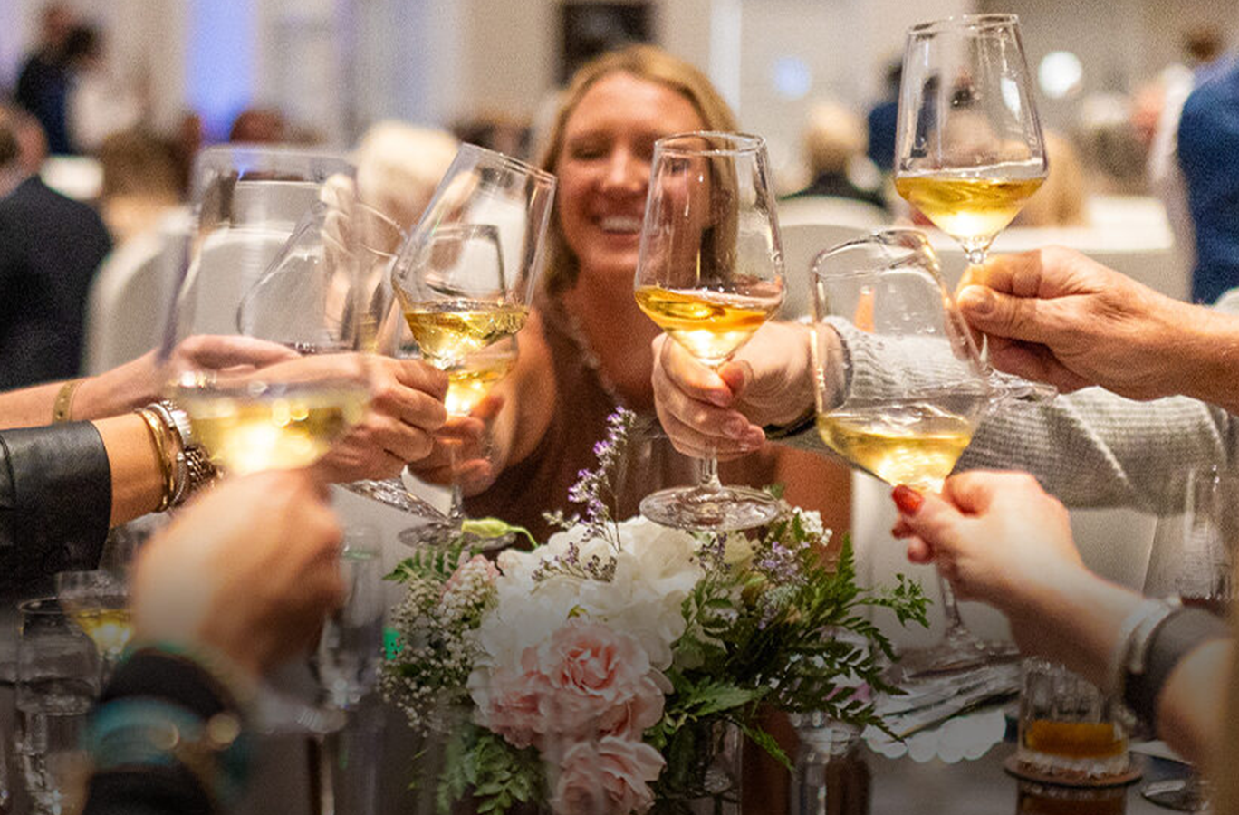 People cheering with wine glasses